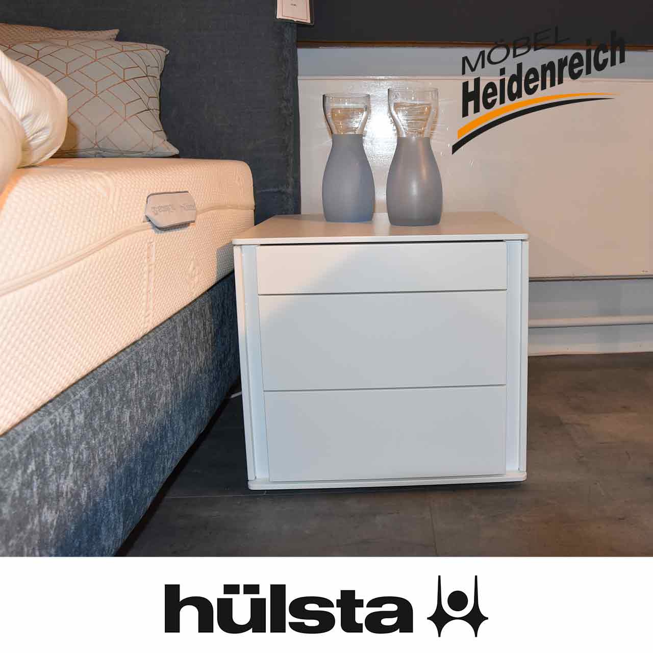 Hülsta Multi-Vidre - Konsole weiß Weiße Konsole mit drei Schubladen ohne Griffe. Die oberste Schublade ist niedriger als die anderen.