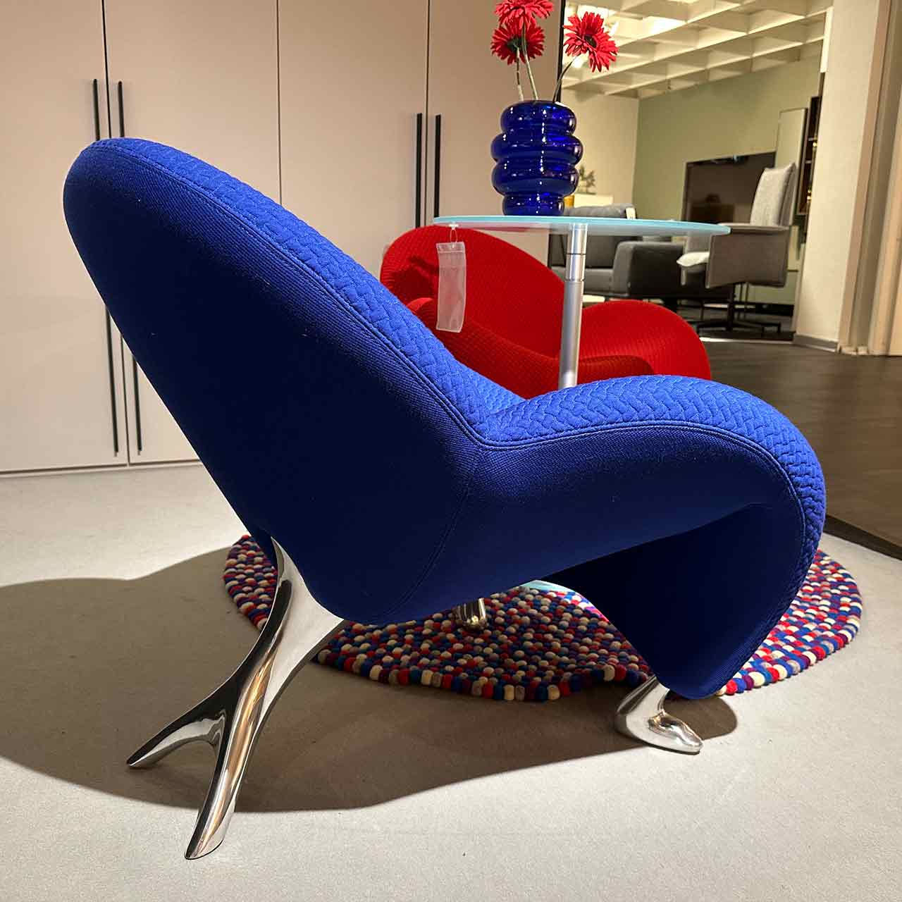 Gleicher Sessel von der Seite, hinterer Fuß mit zwei Gabeln sichtbar, vorne wie Tierfüße.